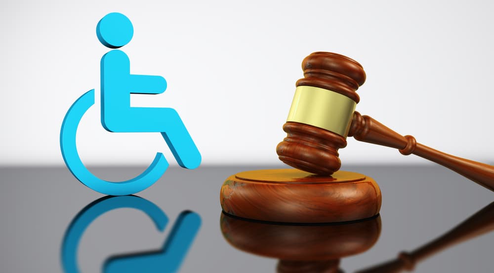 Illustration depicting concepts of disability law, social justice services, and legal acts for disabled people, featuring a judge's gavel and an icon representing a wheelchair in 3D.






