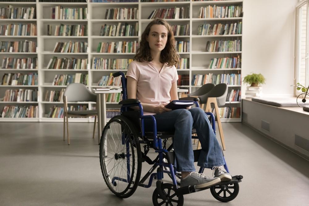 A woman sitting in a library, wondering what objective medical evidence is in disability claims. 