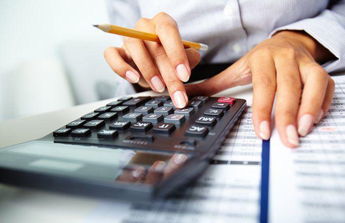 A person working on a calculator, wondering if life insurance is taxable