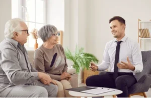 An older couple sits in their living room with their lawyer and ask him, ”Should I accept a disability claim buyout?”