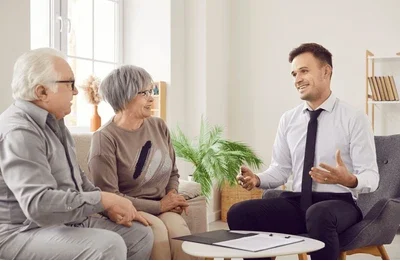 An older couple sits in their living room with their lawyer and ask him, ”Should I accept a disability claim buyout?”