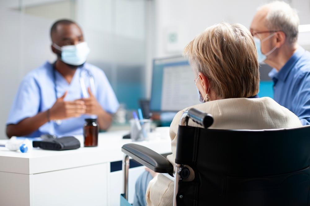 A doctor explaining to a patient what is considered long-term disability in Baton Rouge.