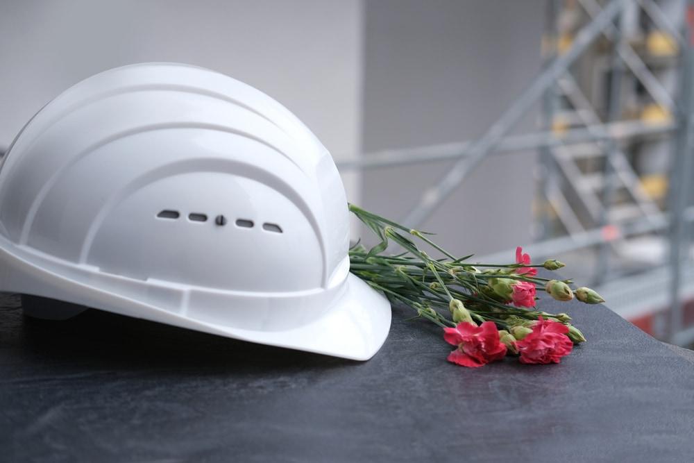 Construction hard hat and flowers arranged as a memorial
